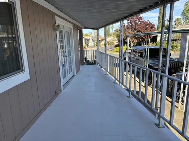 Covered porch featuring french doors