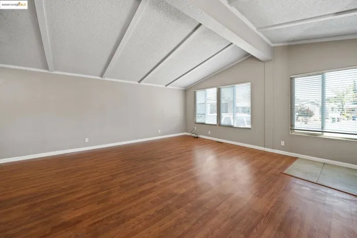 Unfurnished room featuring a textured ceiling and wood finished floors