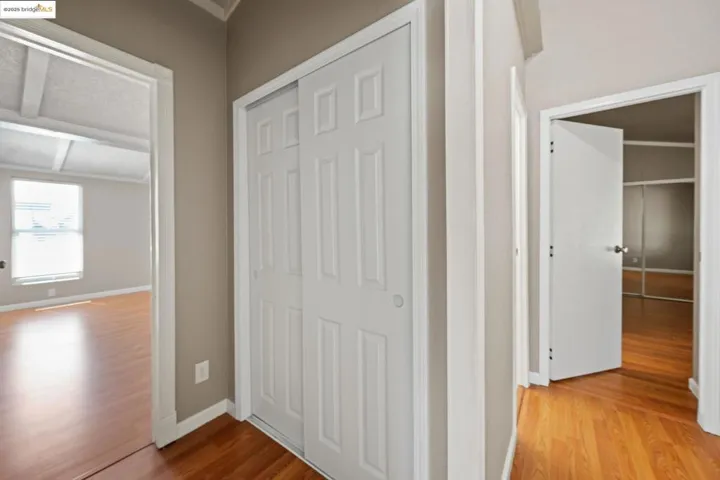 Hall with wood finished floors and baseboards