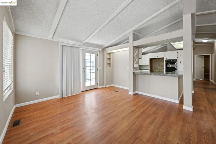 Unfurnished living room featuring a textured ceiling and light wood-style floors
