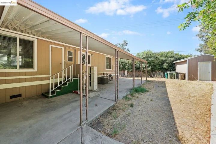 View of patio / terrace featuring a storage unit