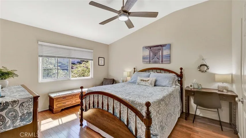 Vaulted ceilings in the primary bedroom with ceiling fan