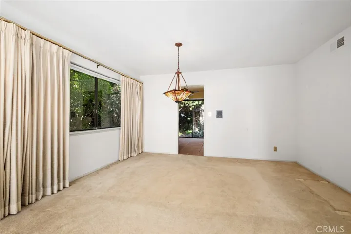 Formal dining room with access to kitchen and backyard.