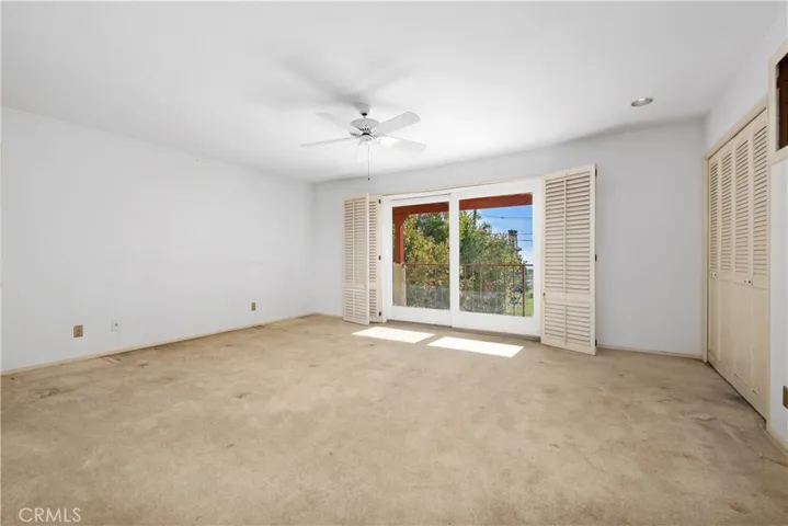 Upstairs large primary bedroom with closet and balcony with view of the ocean