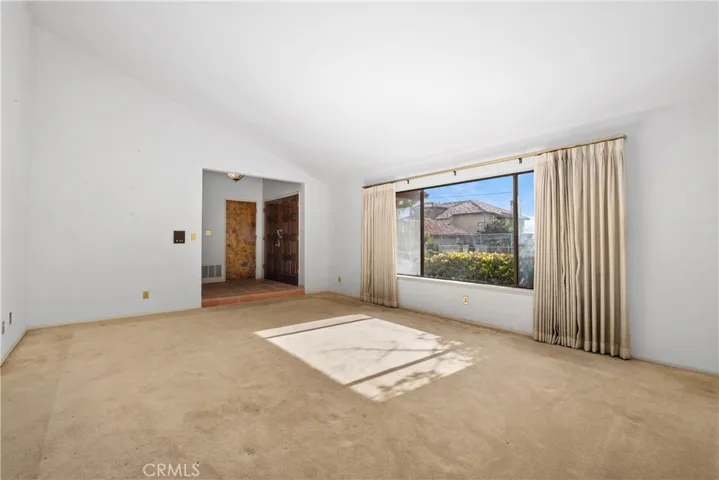 View towards front door and access to garage
