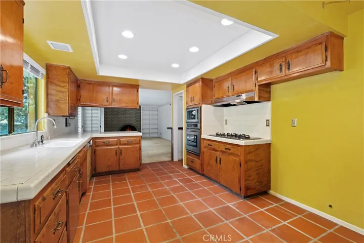 Kitchen leading to family room with fireplace