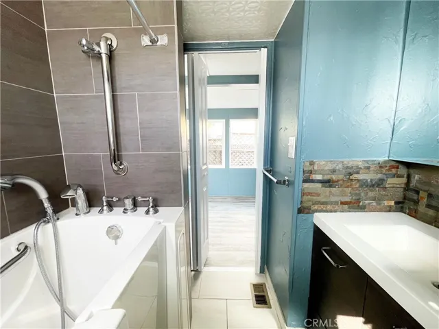 Bathroom showing step-in tub and vanity