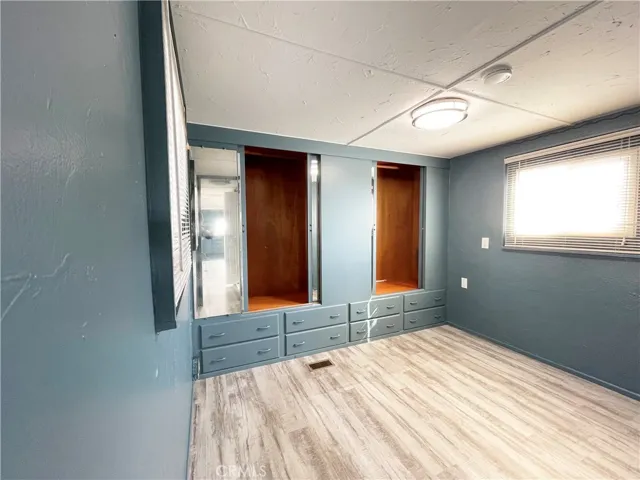 Bedroom with closets open