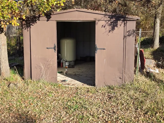 Shed which shelters well equipment and workbench