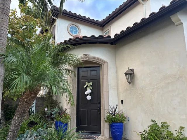 Smooth stucco walls and stone moldings around the door.