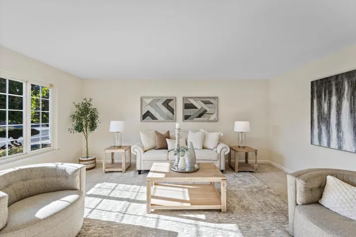 immediately as you enter the front door the spacious living room is to your left