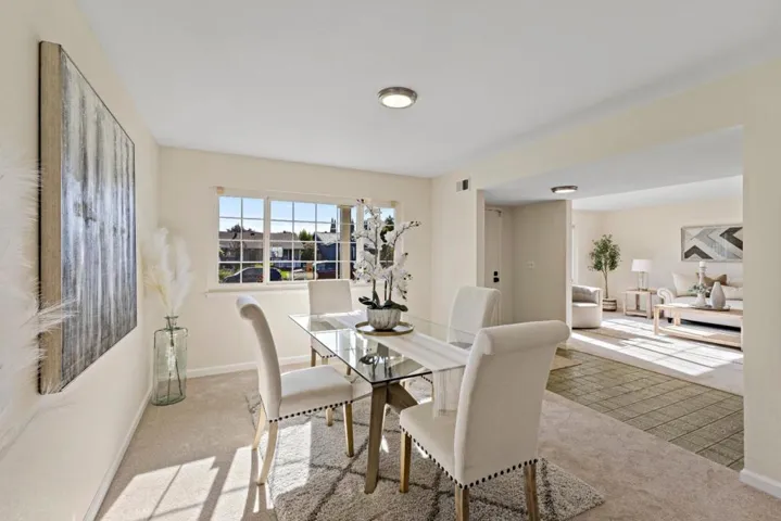 vantage point looking at entry, living and dining from the kitchen pass thru door