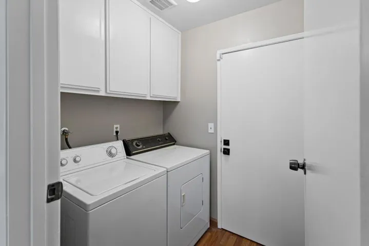 indoor laundry between garage and living spaces has extra storage too