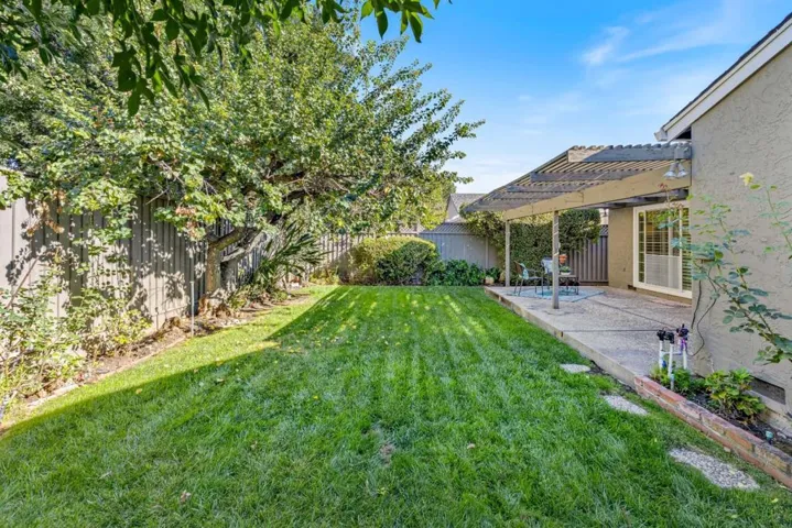 mature landscaping in rear of home matches the front's personality - charming and quaint