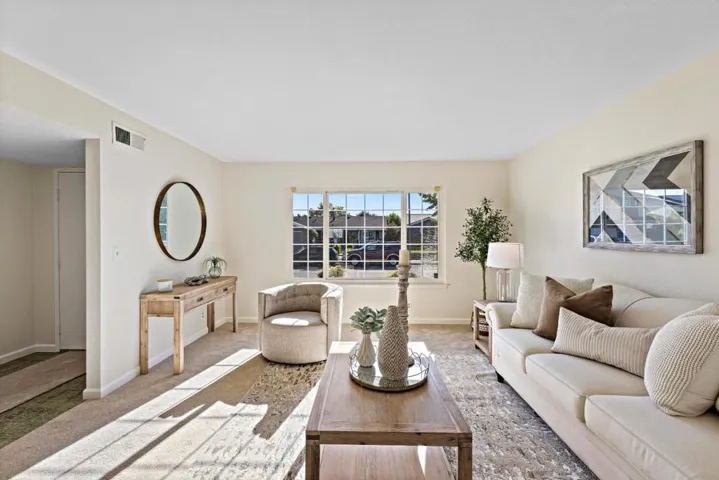 the light and airy living room faces the front of the home [ front door is to the left - inset