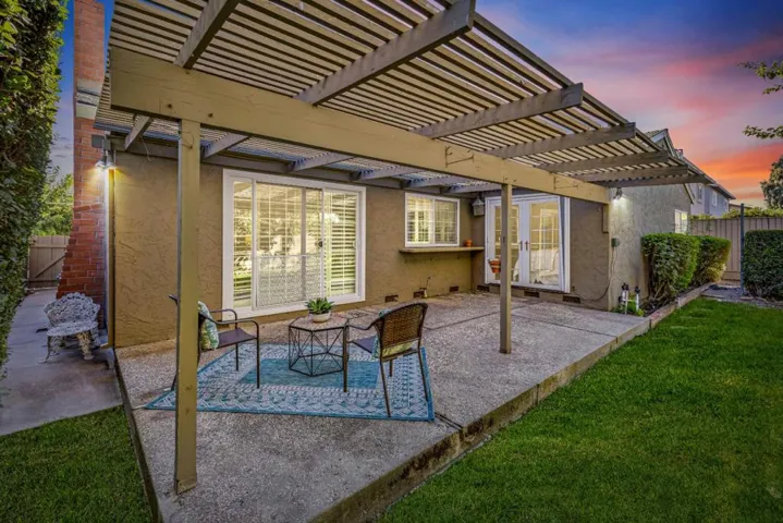 family room slider, kitchen window and french doors off primary suite leading to patio
