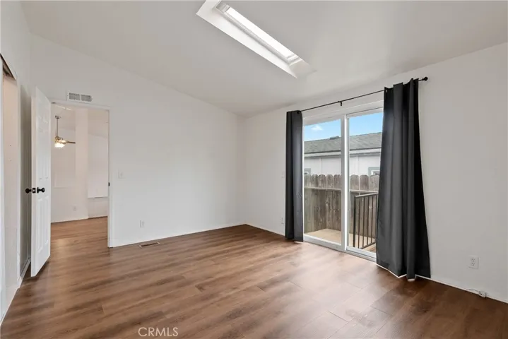 Generous space and laminate wood floors give the primary bedroom a polished feel!