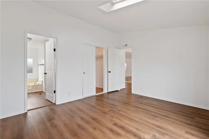 The primary bedroom has a walk in closet with a light.