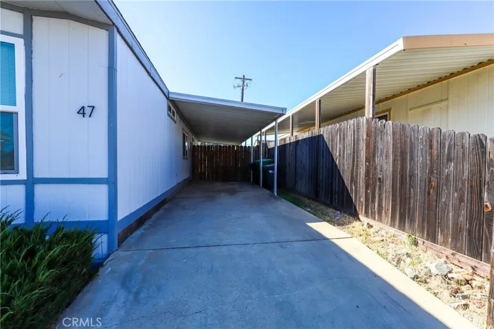 On the side of the home is a carport for parking. There is guest parking across the street.