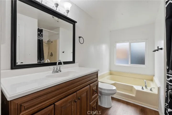 The ensuite bathroom boasts a sizable, updated vanity.