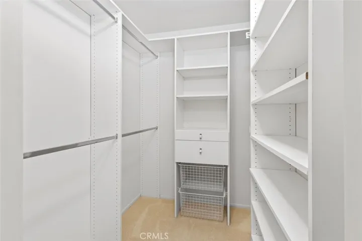 A walk-in closet in the main bedroom.