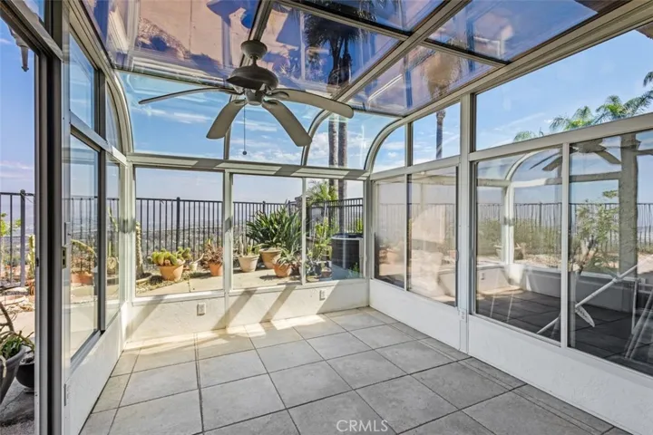 This is an attached solarium or greenhouse. It is located off the family room, (at the rear of the house).