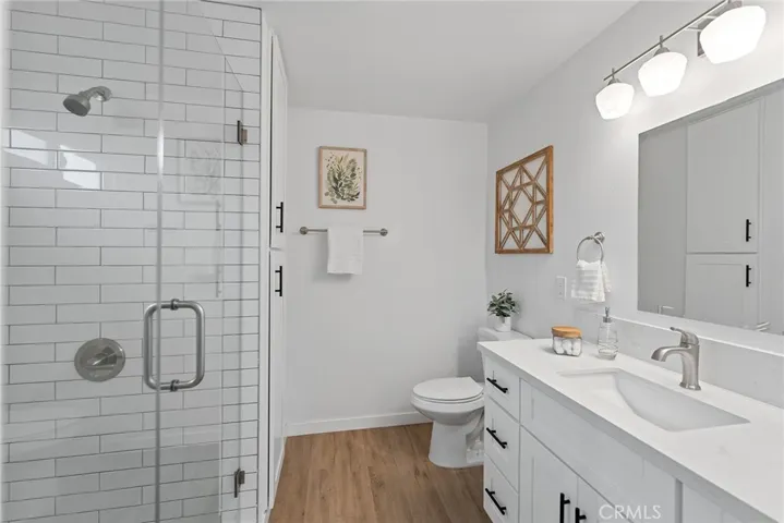 This en suite bath has a linen closet to the right of the shower