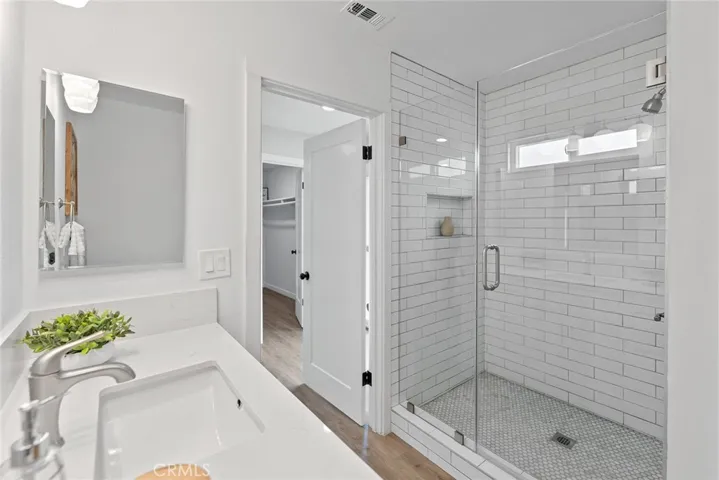 This bathroom is beautifully designed with its large shower and window that opens