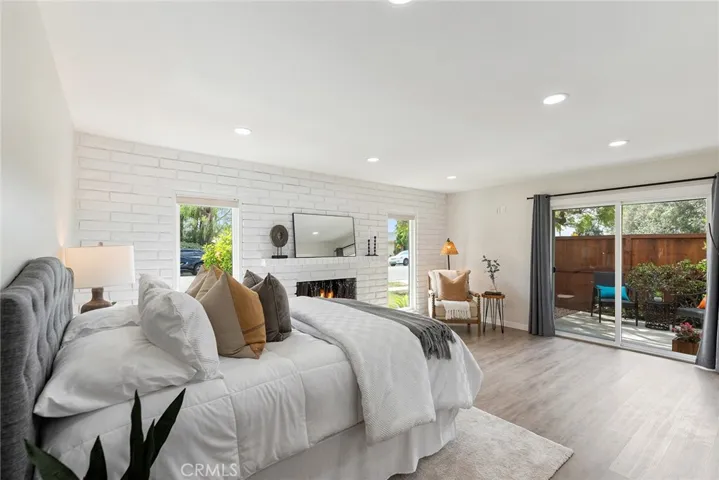 This first primary en suite bedroom has a wood burning fireplace and a private patio
