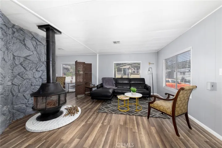 Living room with charming, rustic wood fireplace