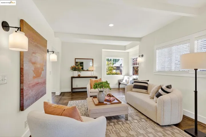 Living area featuring beamed ceiling, and hardwood floors