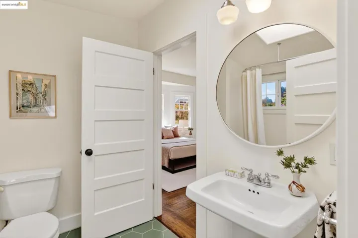 Main level bathroom with clawfoot tub and skylight