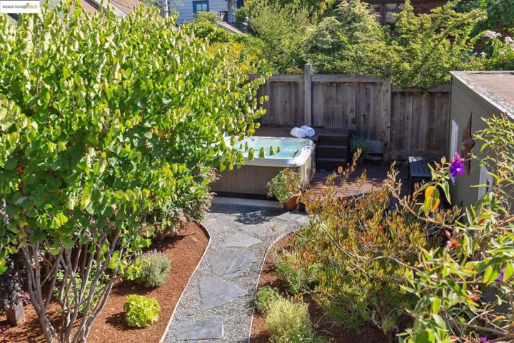 View of yard from deck, featuring a hot tub