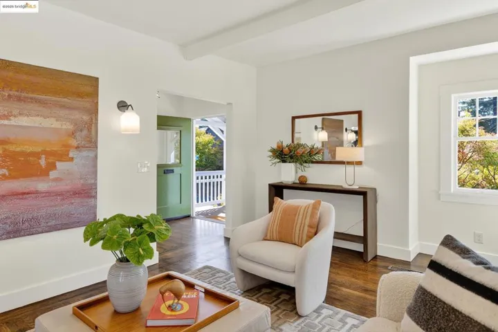 Living area with beamed ceiling and wood floors