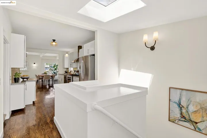 From the main level, looking back to kitchen, stairs to lower level, and skylight