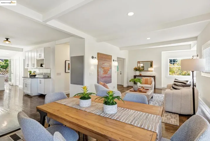 Dining room with hardwood floors, open to living room and kitchen