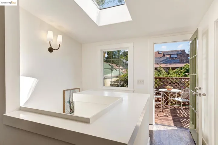 From the main level, the door to the deck, stairs to lower level, and skylight