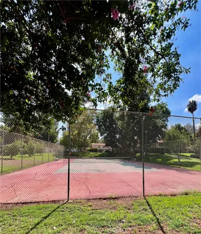 Tennis court next to pool area