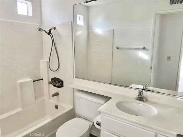 Secondary bathroom with shower over tub.