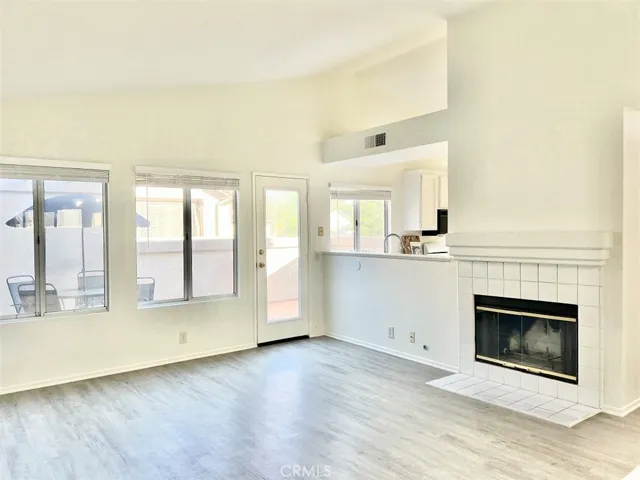 Living room with fireplace and door leading to balcony area.