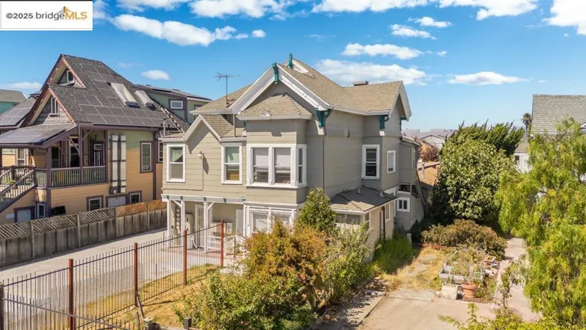 Back of property featuring a residential view and roof with shingles
