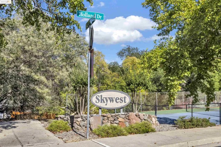 Community / neighborhood sign featuring view of scattered trees