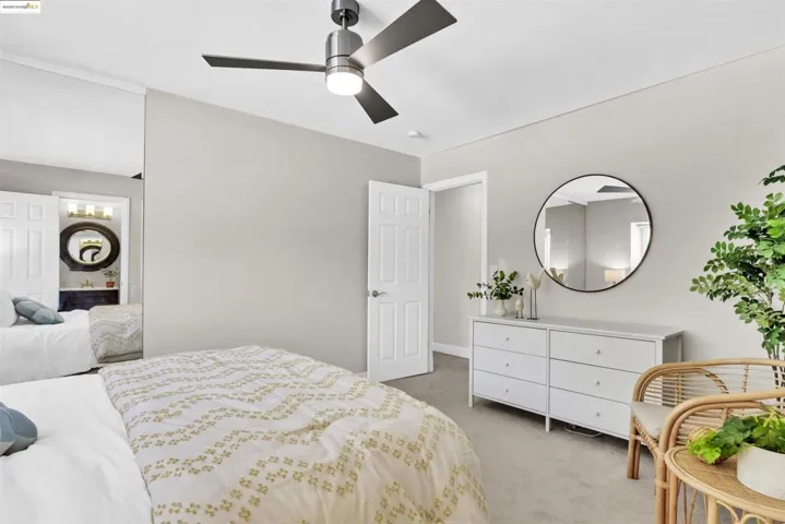 Bedroom featuring light carpet and a ceiling fan