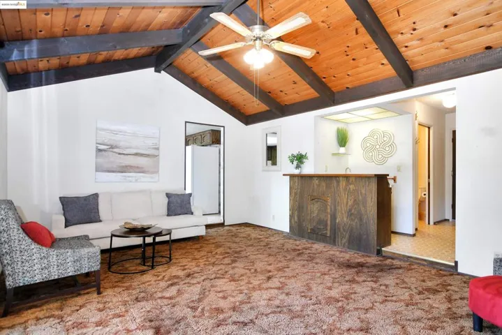 Sitting room with carpet floors, ceiling fan, and wooden ceiling