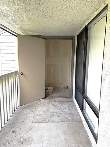 Rear patio with storage closet at the end of the living room with amazing views of city lights and foothills.
