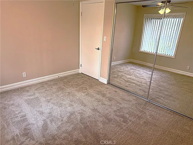 Mirrored closet doors in bedroom two.