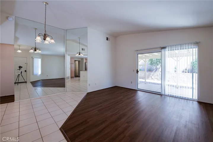 Living room, dining room and slider to the rear covered patio and gardens.