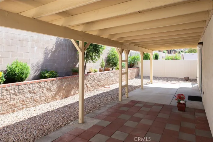 Concrete and paver covered patios, lush gardens and block walls.