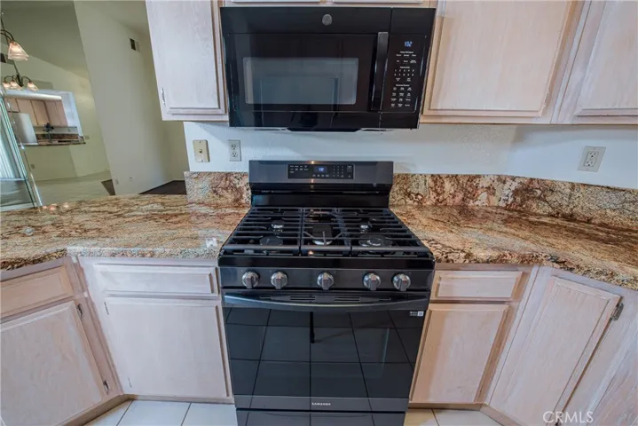 Newer 5-burner gas range and microwave.
