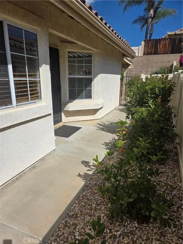 Side entry with lovely gardens.